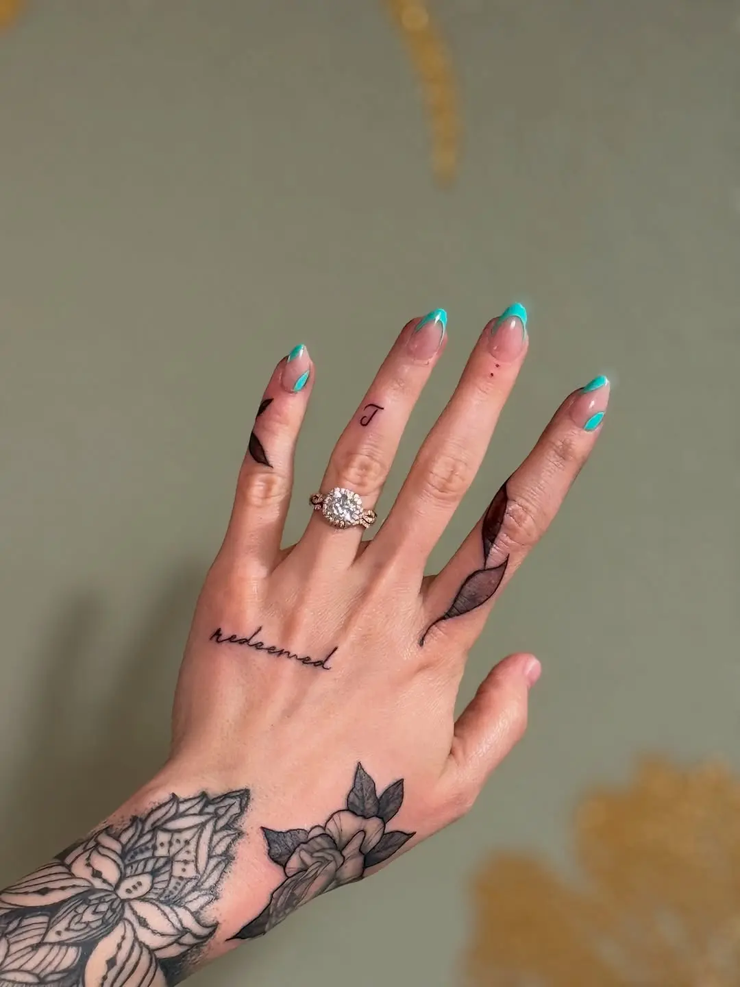 Intricate Christian tattoos on a hand