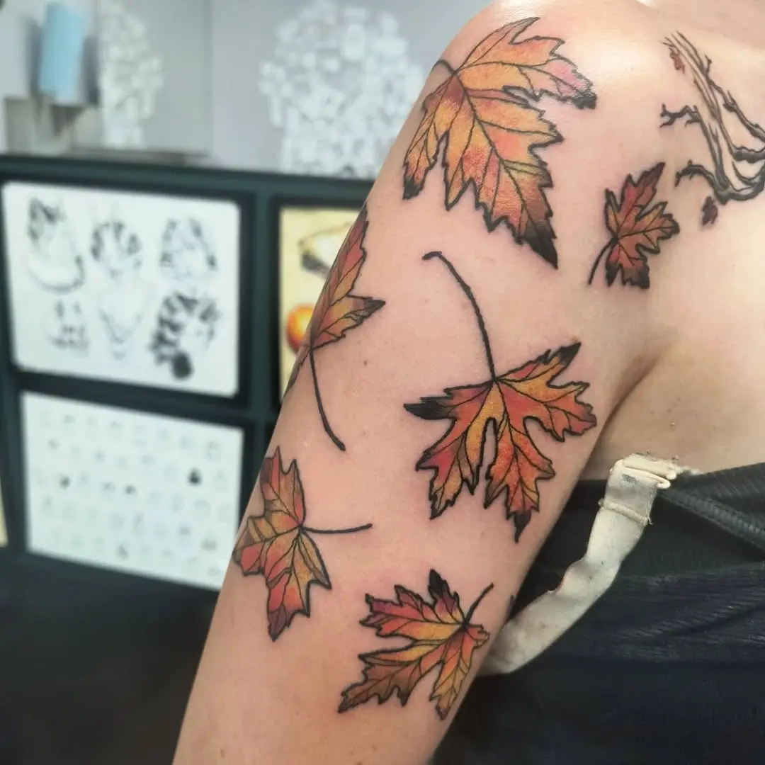 Vibrant autumn leaves inked on skin