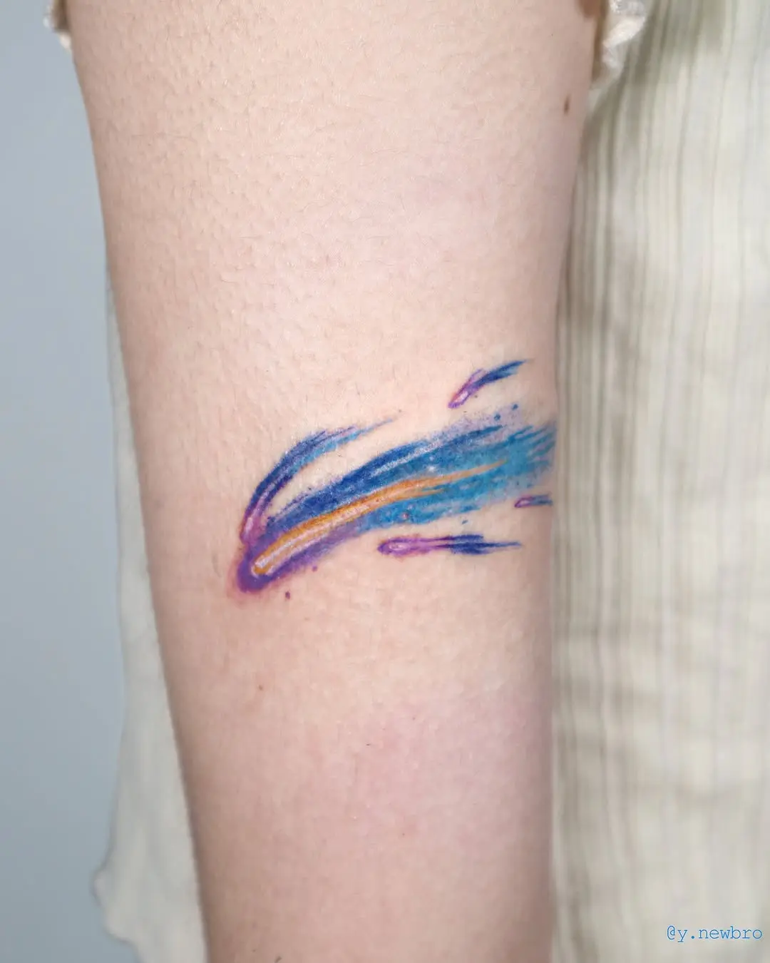 Vibrant meteor tattoo with swirling colors