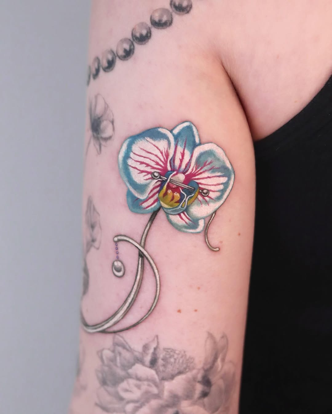 Vibrant orchid tattoo with intricate details