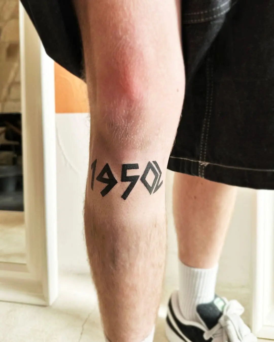 Modern 1950 Date Tattoo with Sharp Angles