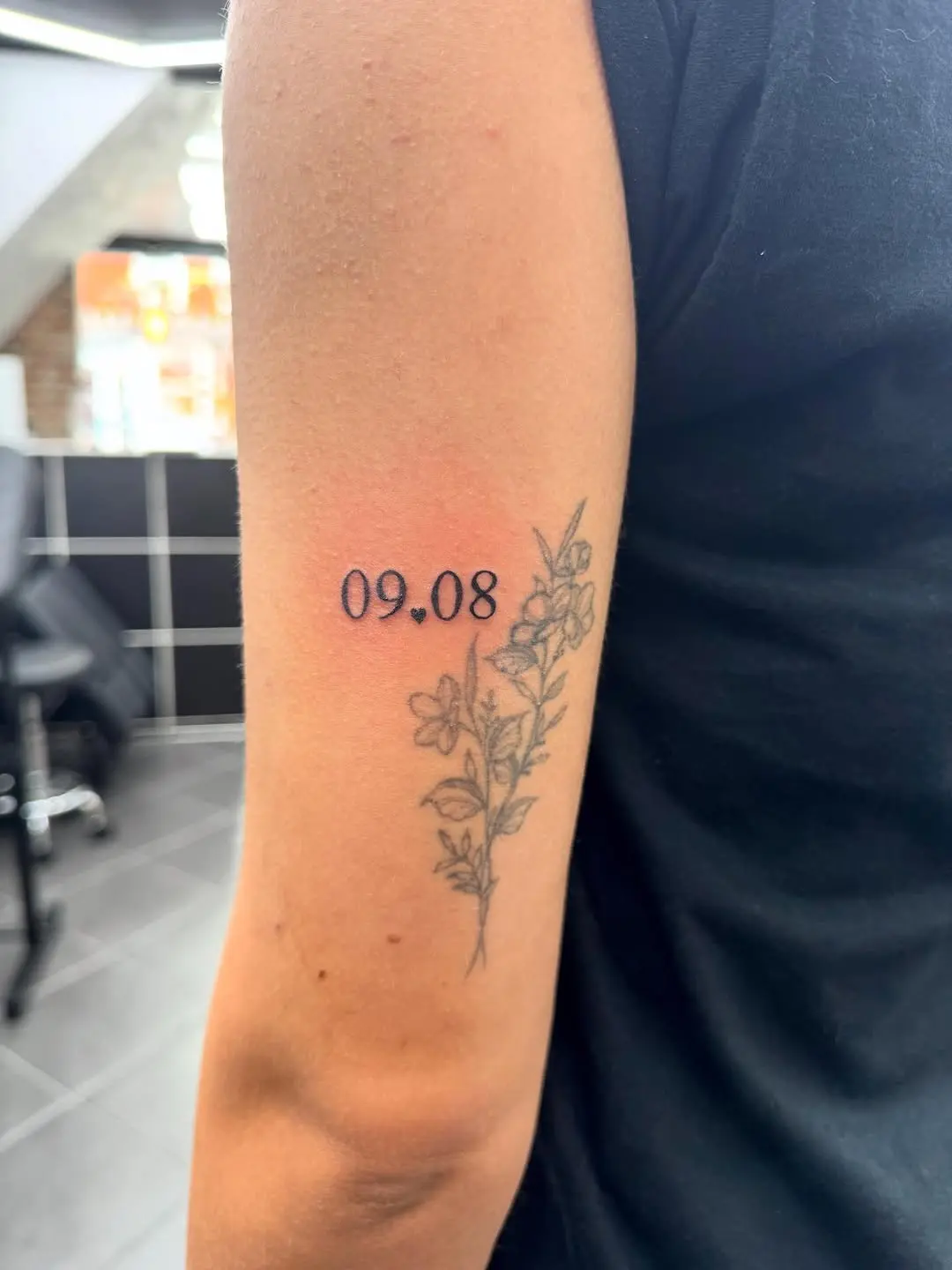 A beautiful date tattoo with floral accents