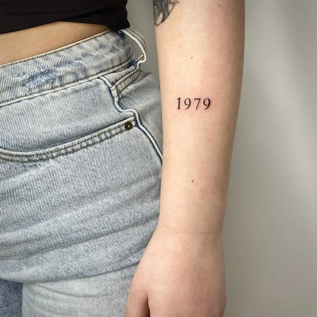 Minimalist date tattoo in elegant script