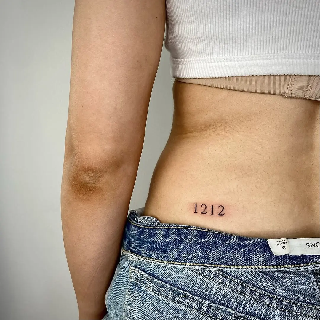 Minimalist date tattoo on woman's body