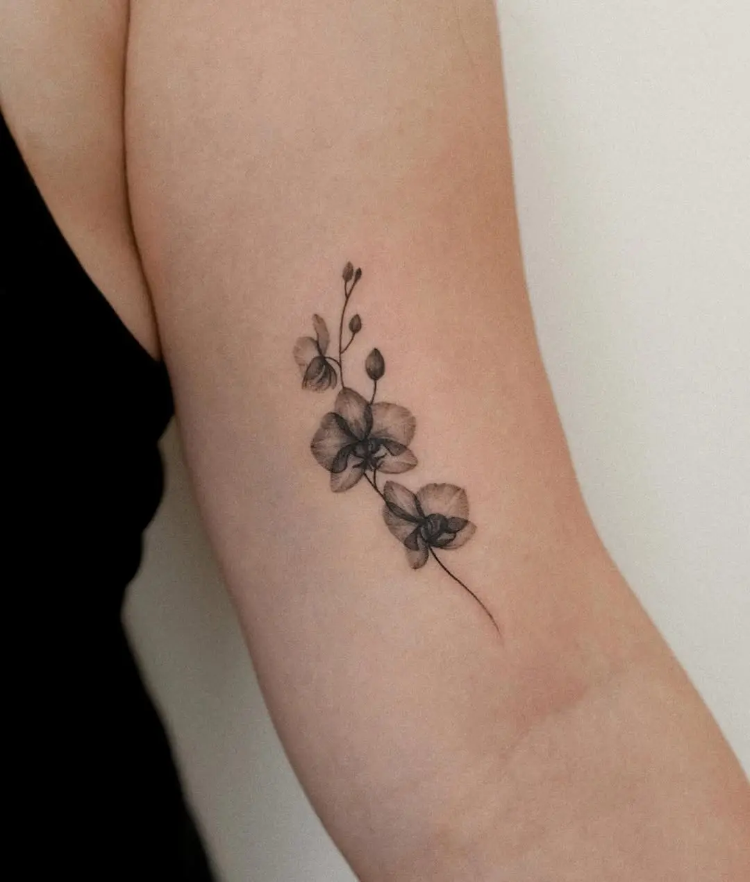Elegantly unique black and white orchid tattoo