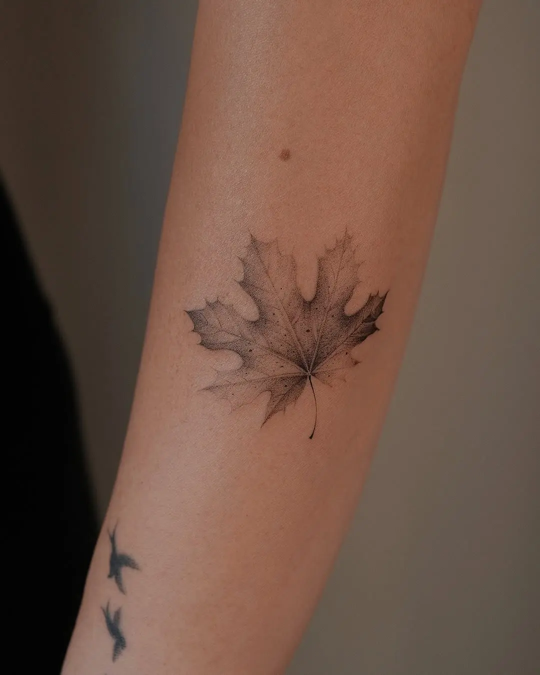 Intricate black ink maple leaf tattoo