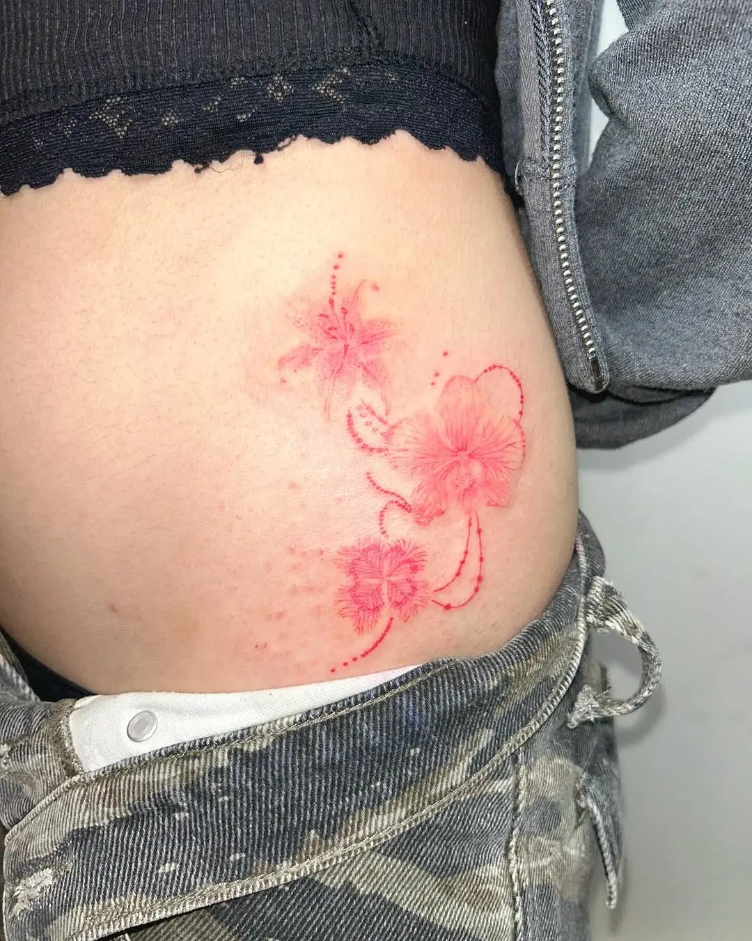Delicate orchid tattoo with a romantic vibe