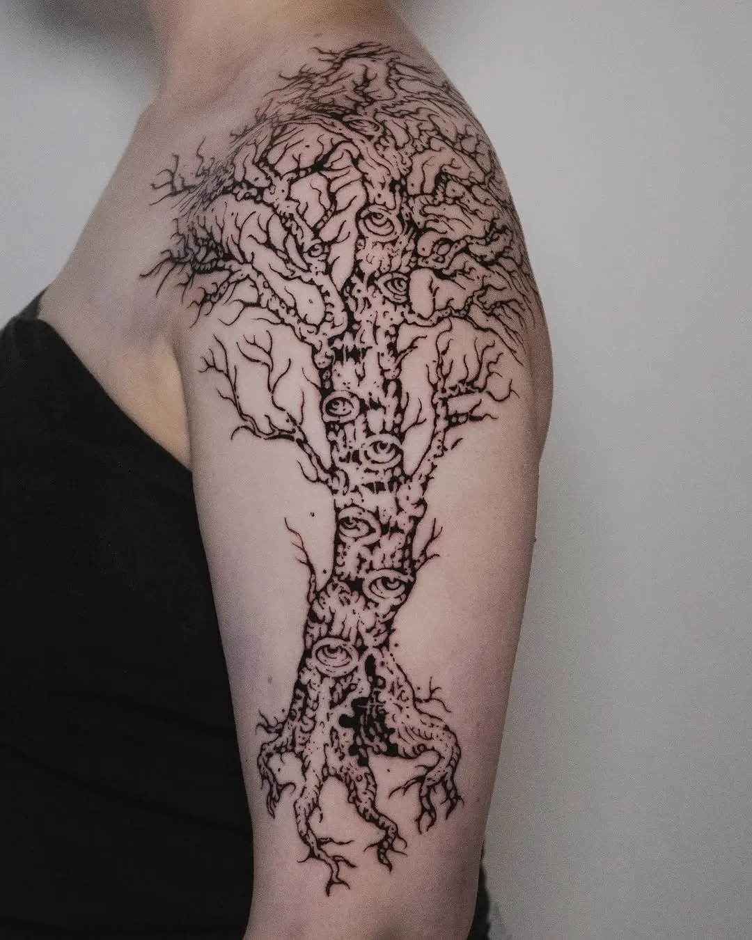 Intricate birch tree tattoo with eye motifs