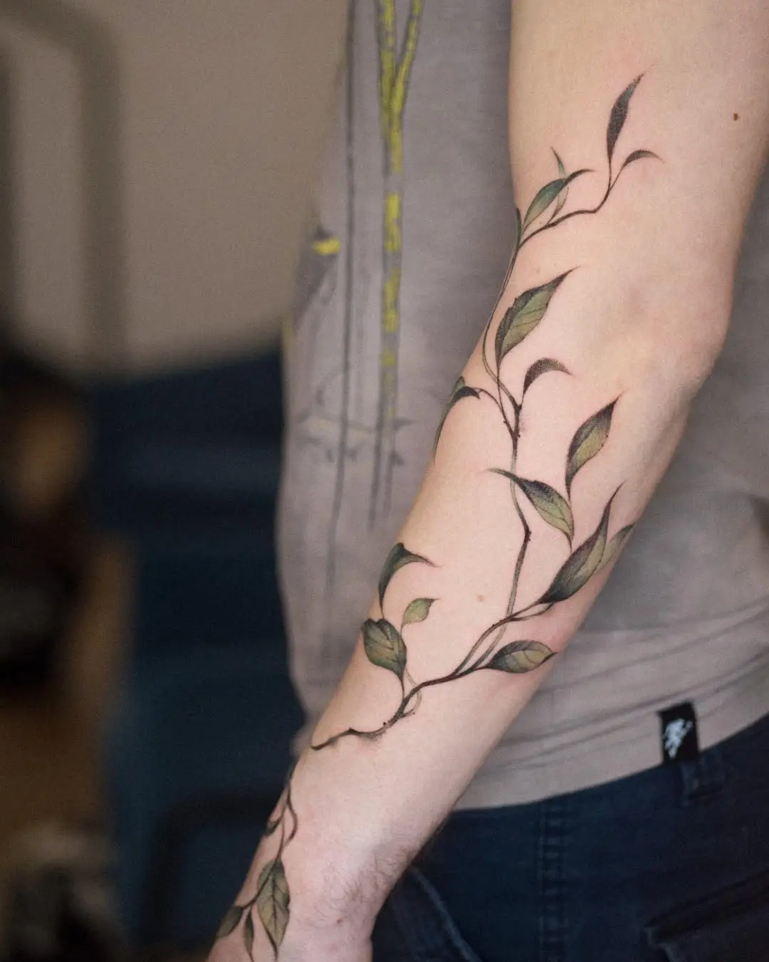 Elegant ivy tattoo winding around the forearm