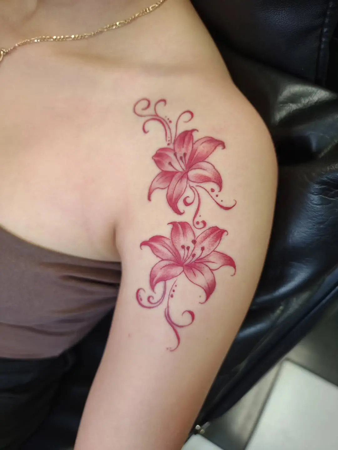 Stunning lily tattoo on upper arm