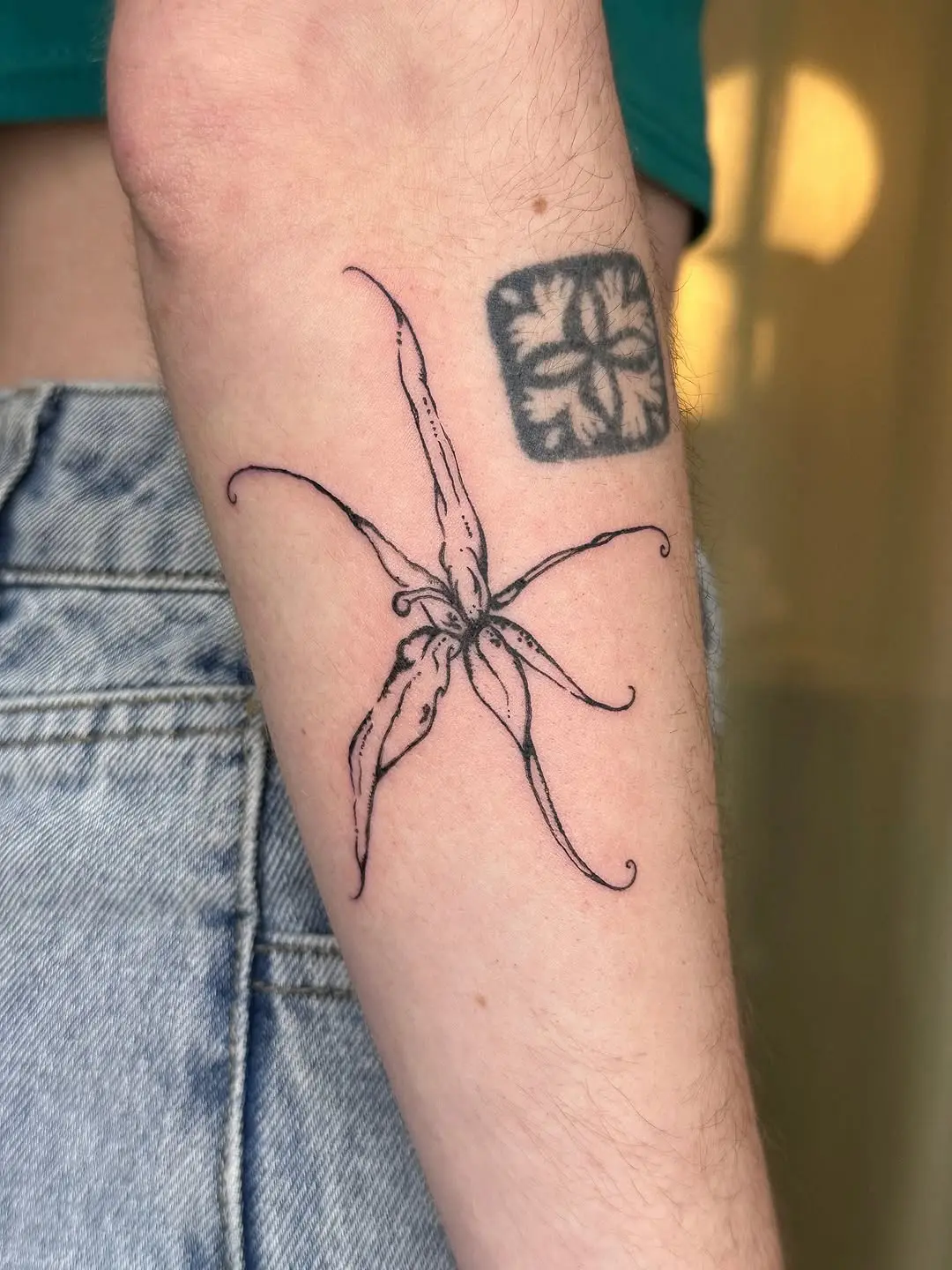 Elegant black outline orchid tattoo design
