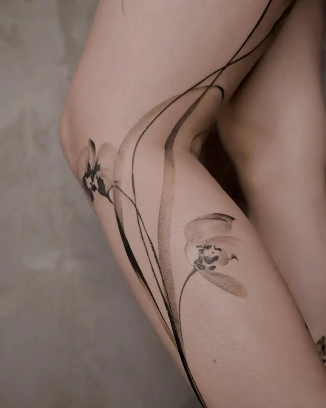 Stunning orchid tattoo with fluid lines