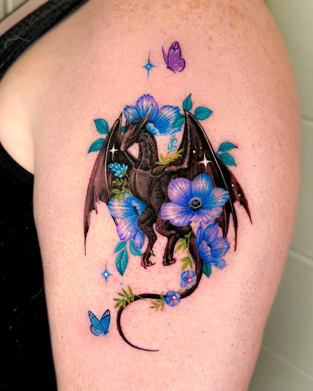 A striking dragon tattoo surrounded by flowers
