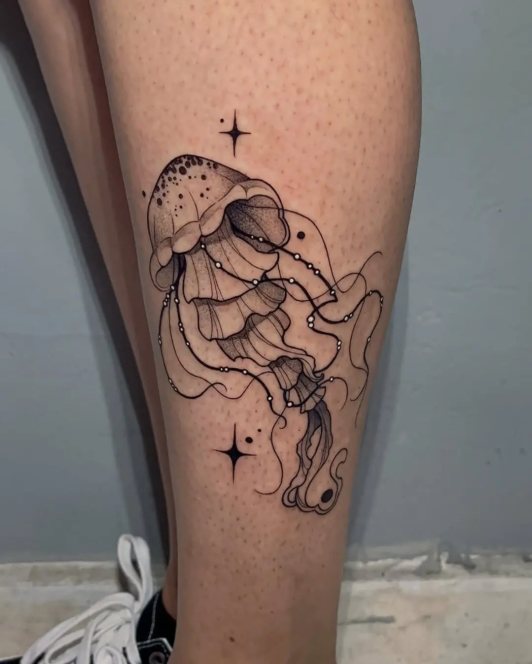Intricate jellyfish tattoo with cosmic elements