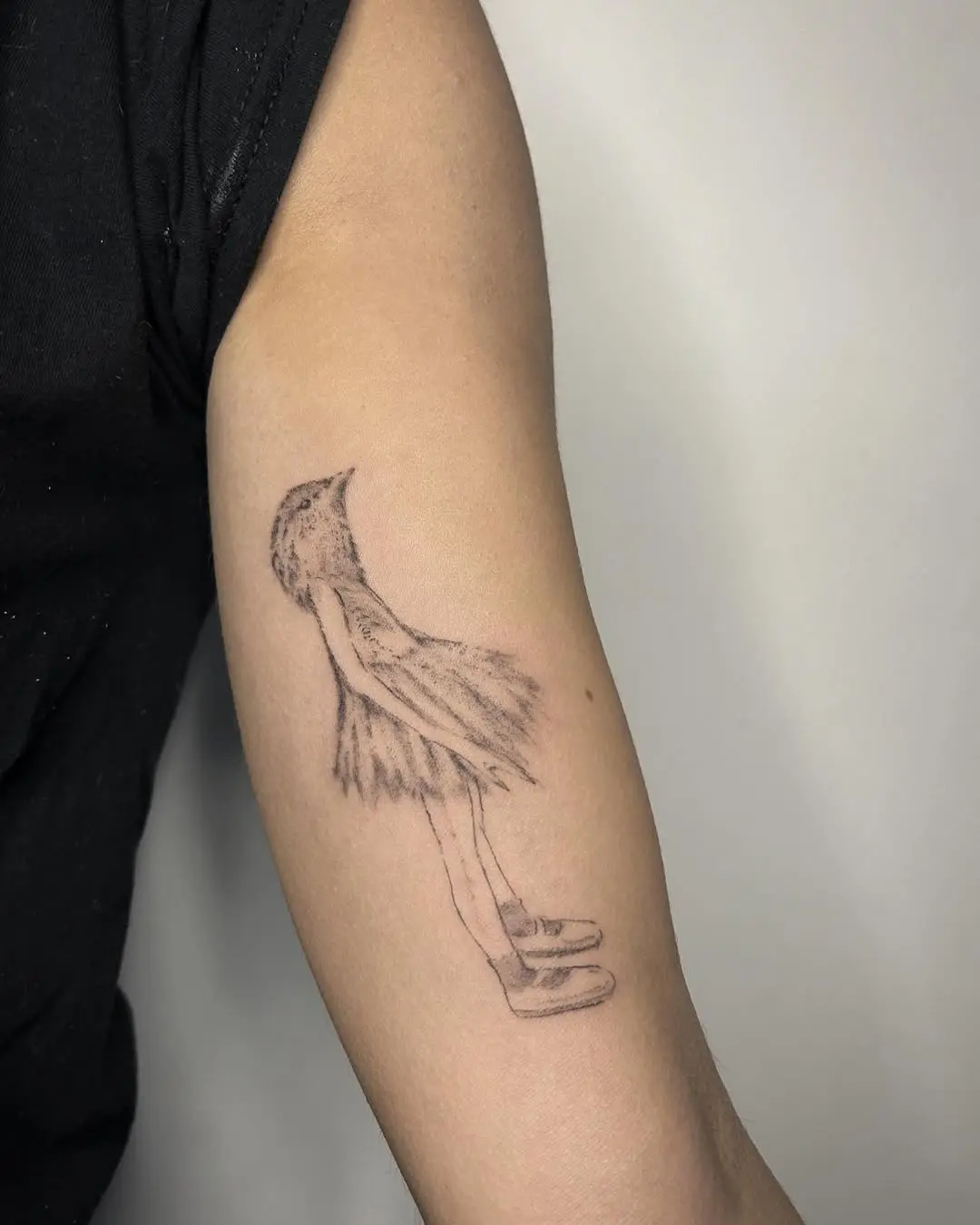 Whimsical bird dancer tattoo adds ethereal charm