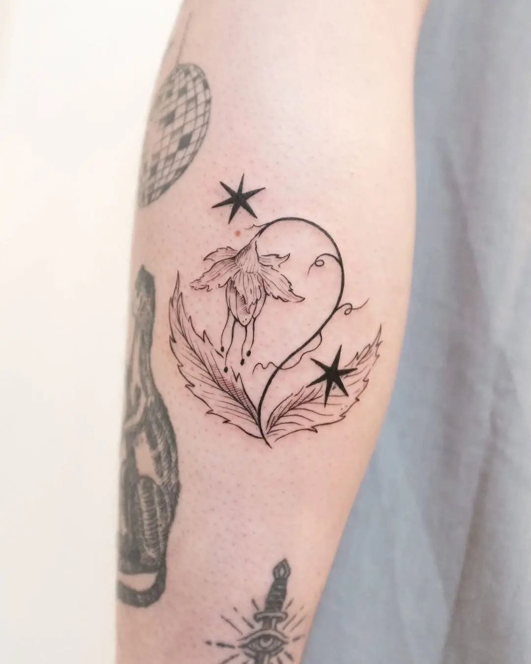Delicate flower and stars tattoo design