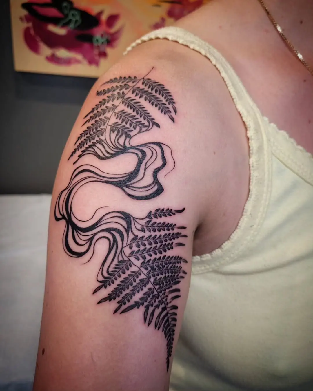Elegant fern leaf tattoo on the shoulder