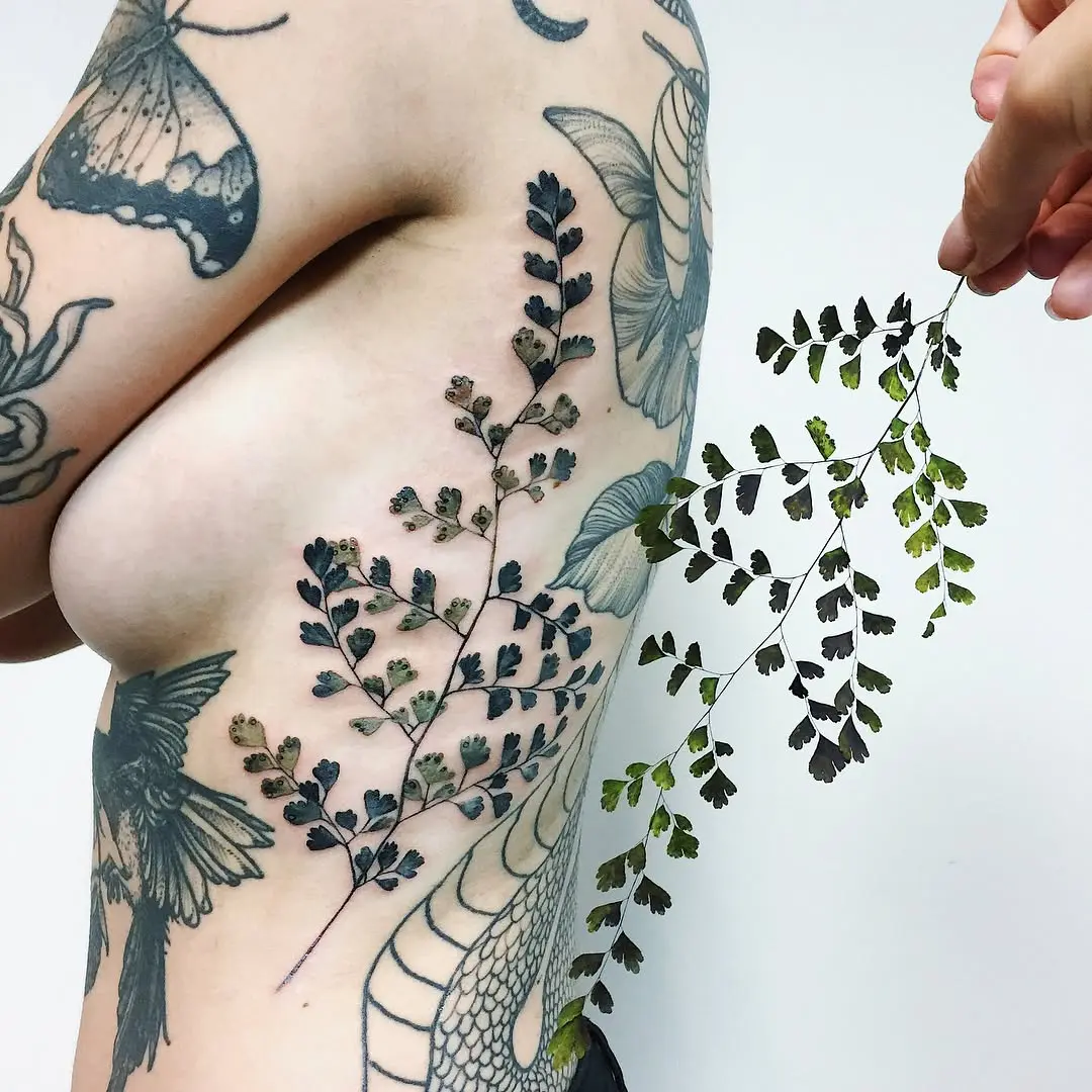 Whimsical fern tattoo showcasing nature's beauty.