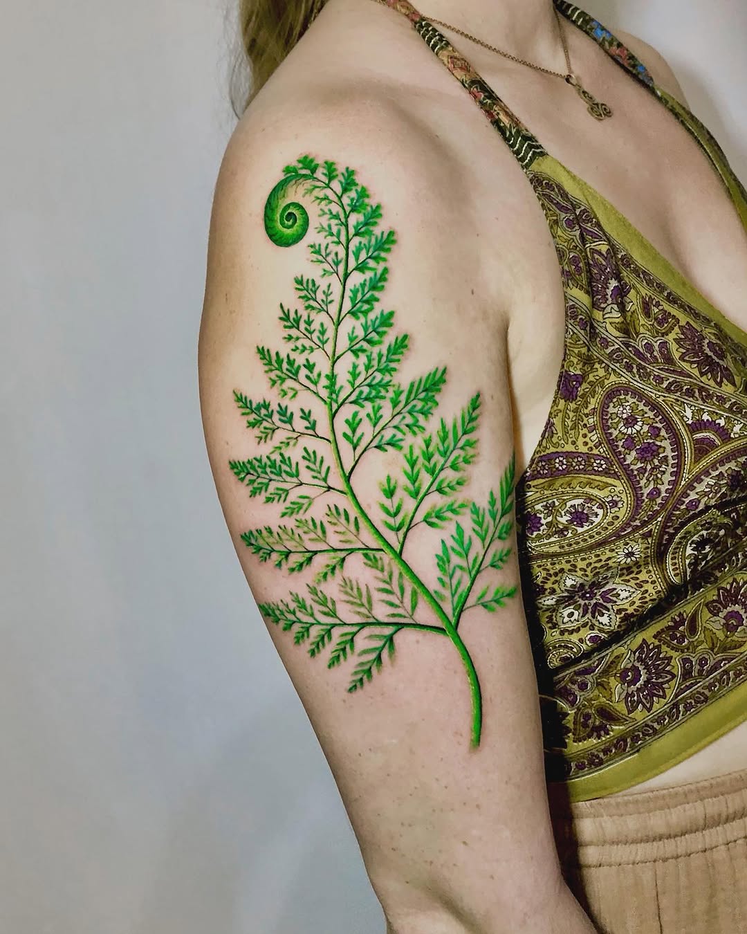 Elegant fern leaf tattoo on the arm