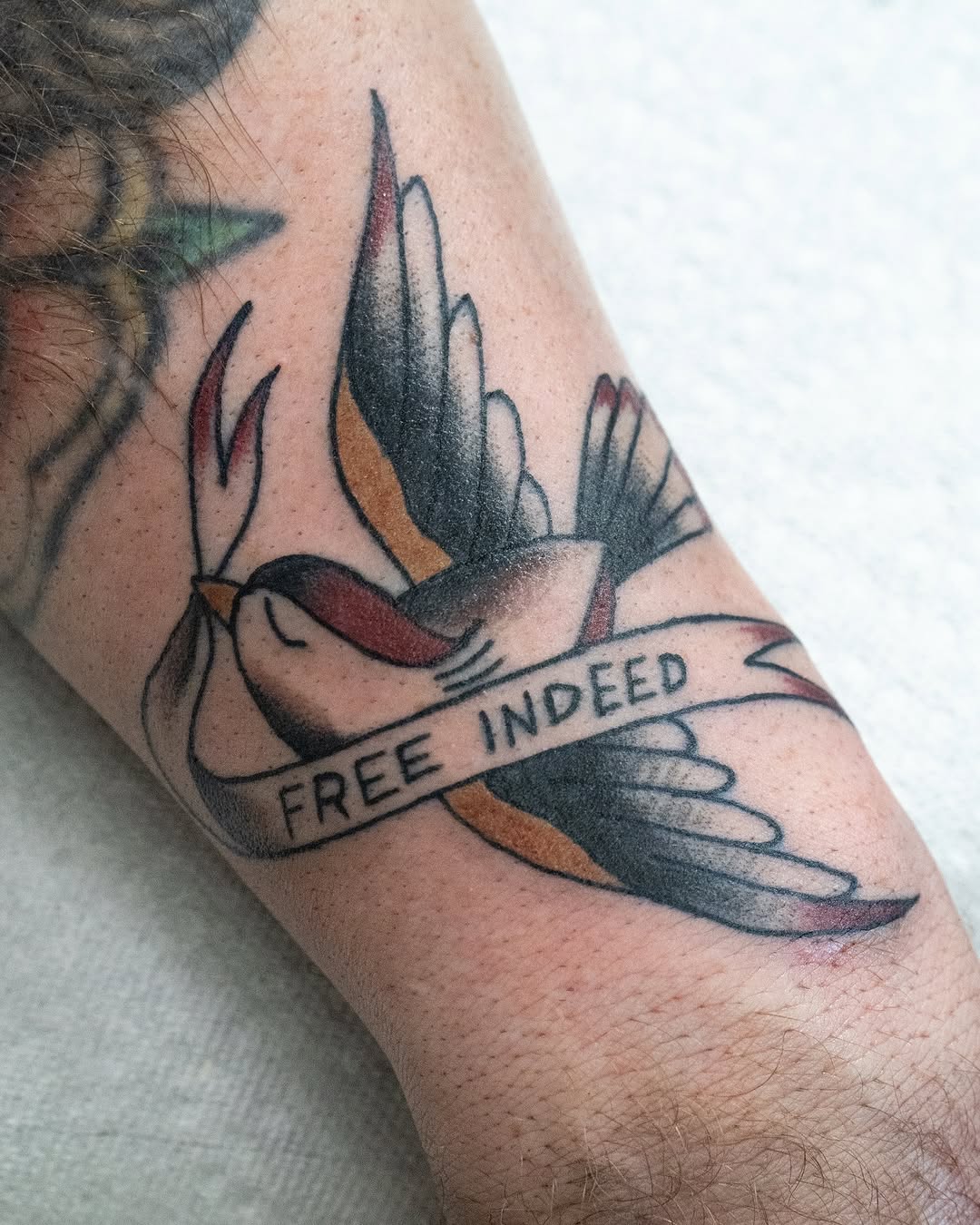 Elegant tattoo symbolizing freedom and faith