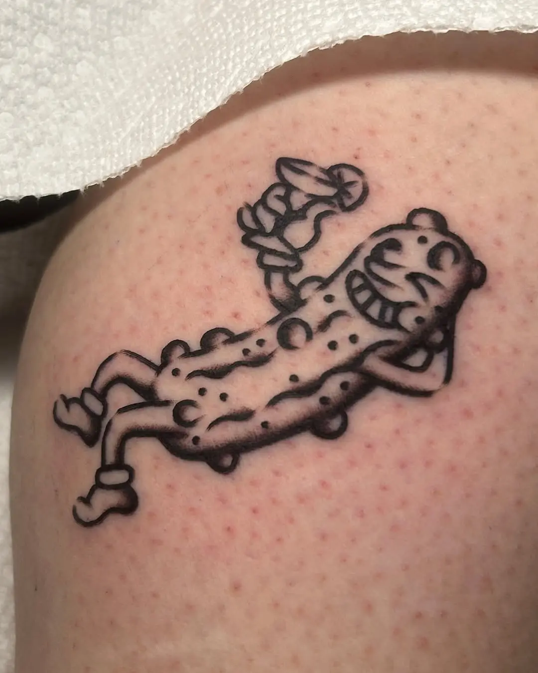 Whimsical pickle tattoo with playful vibes