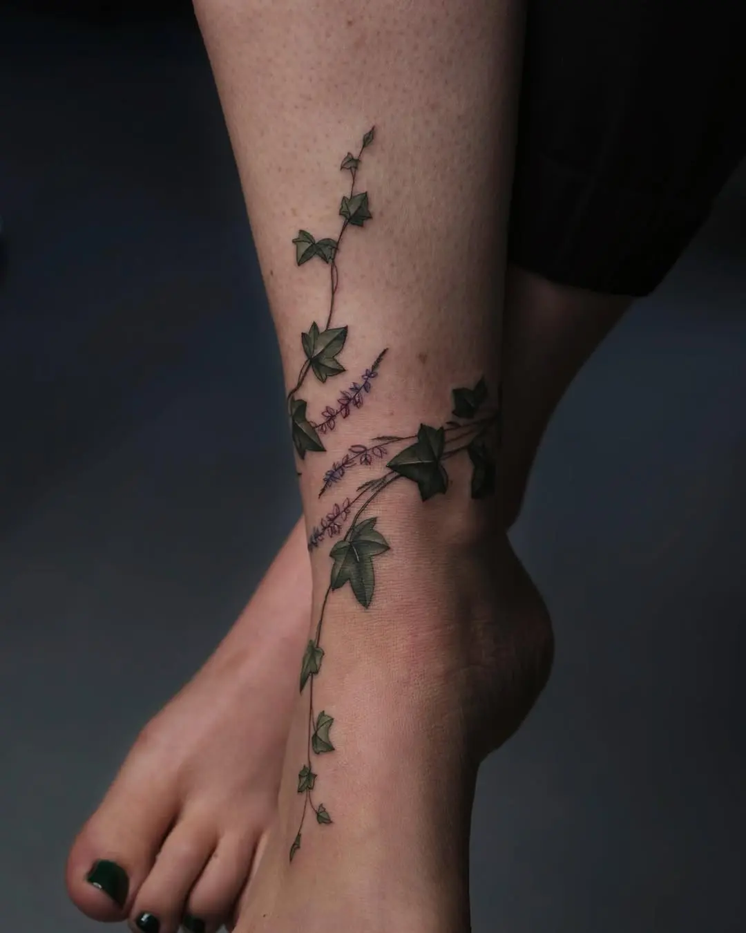 Elegant ivy tattoo wrapping around the ankle