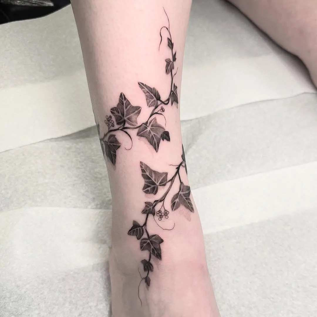 Elegant ivy tattoo wrapping around the leg