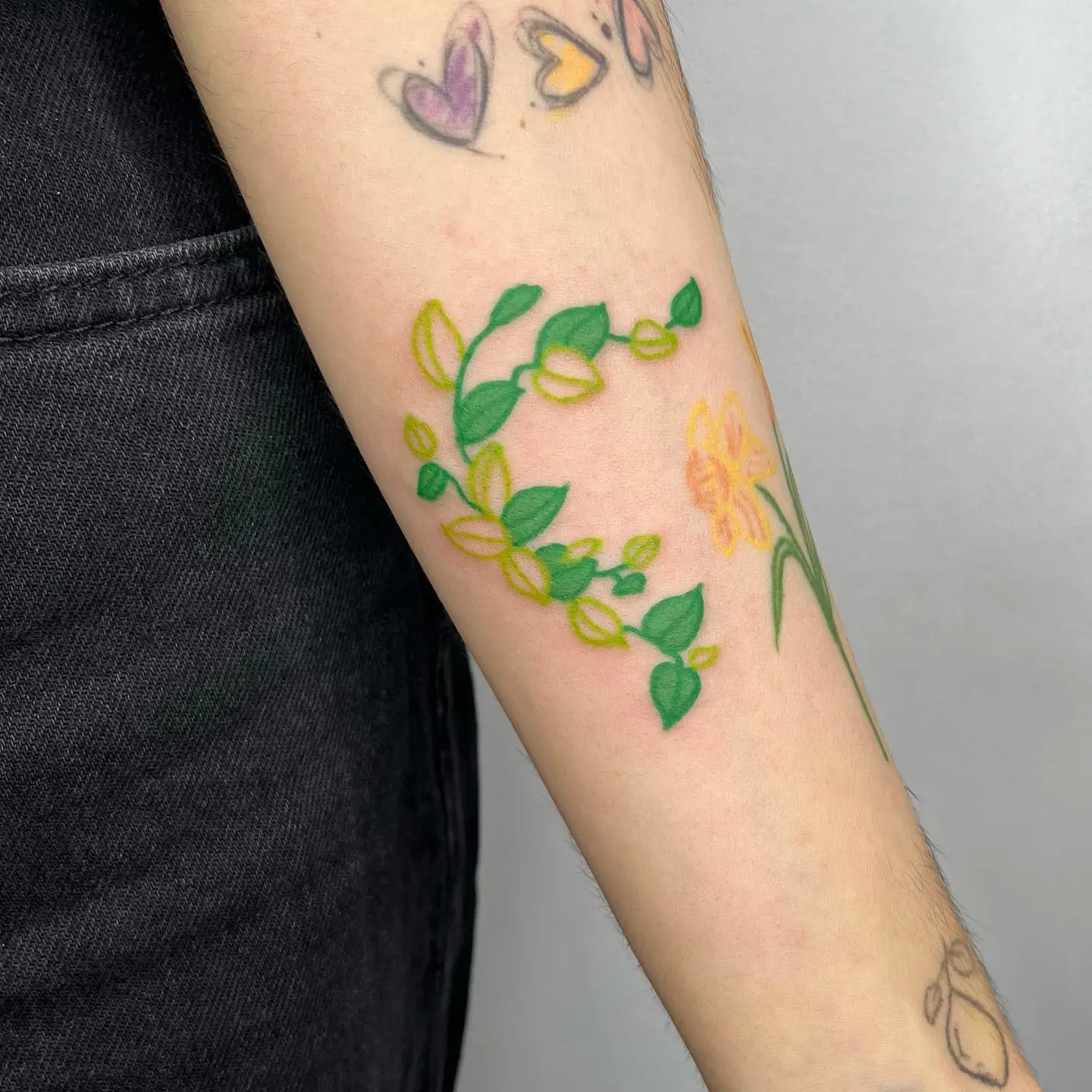 Elegant ivy tattoo with floral accents