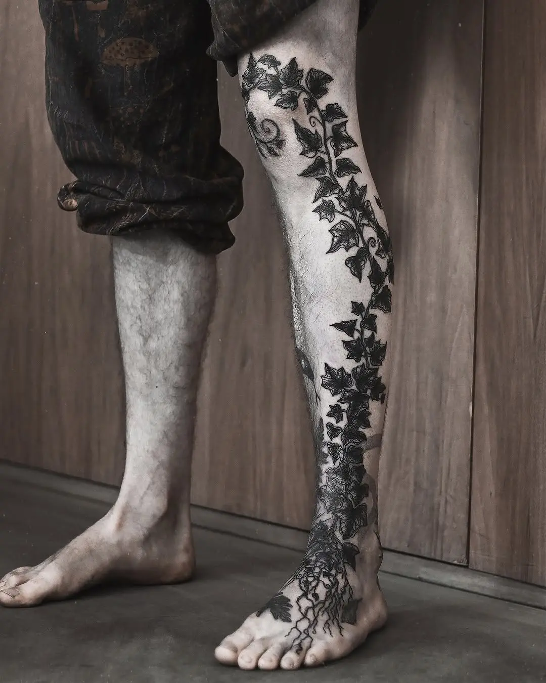 Intricate ivy tattoo wrapping around the leg