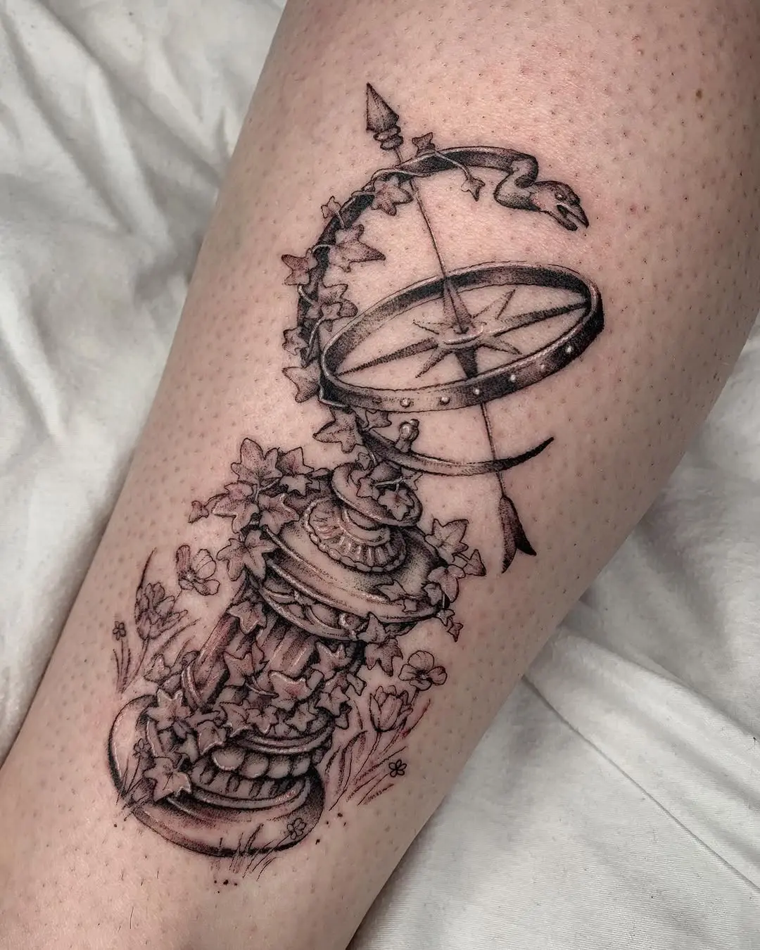Intricate ivy tattoo entwined with a sundial