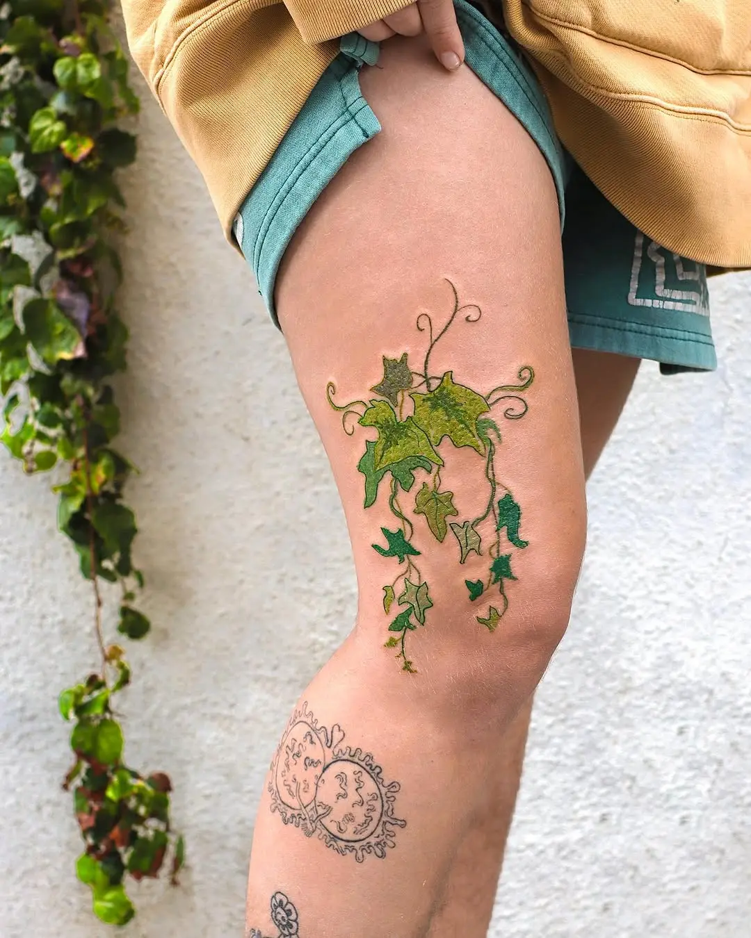 Elegant ivy tattoo cascading down the thigh