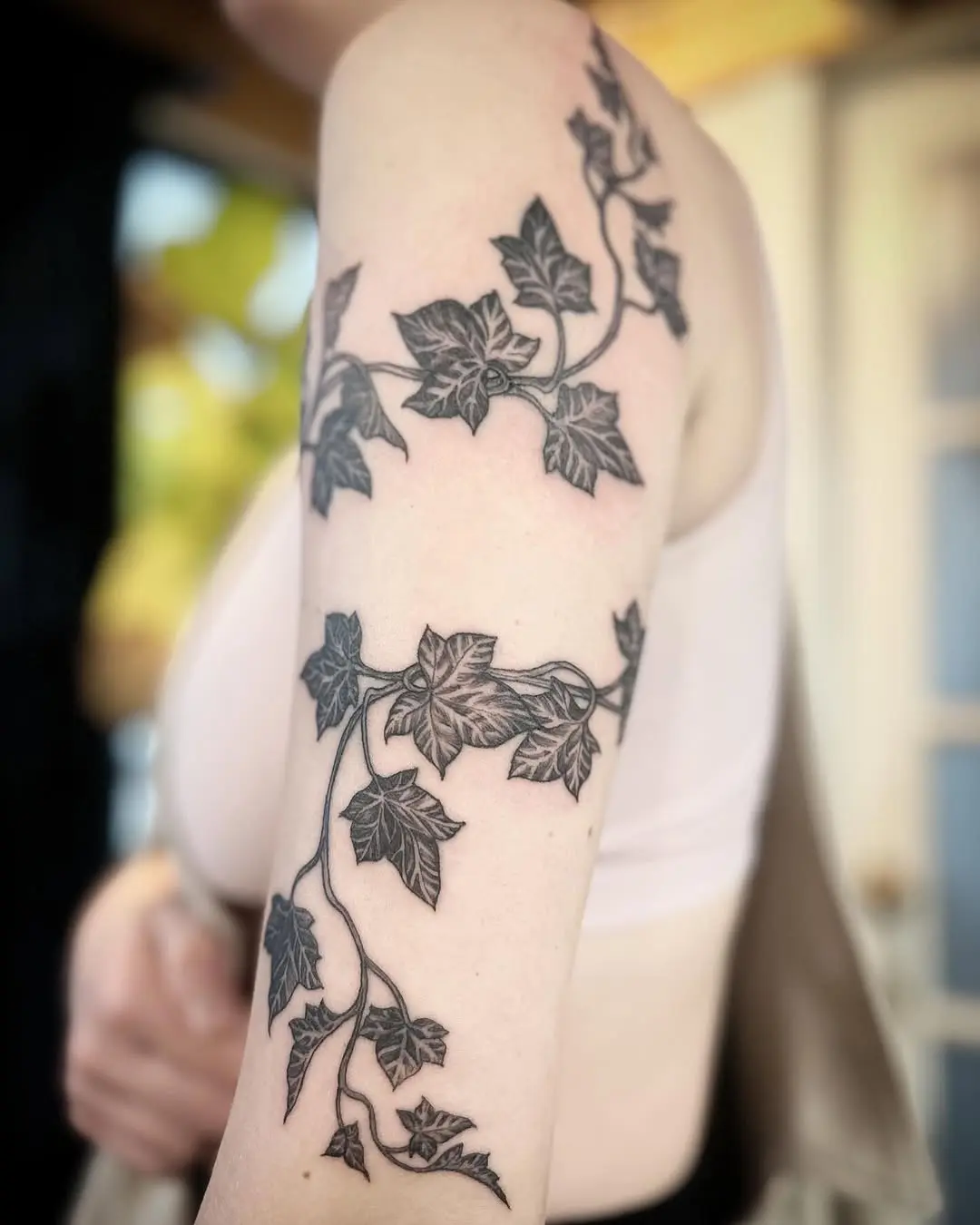 Elegant Ivy Tattoo Wraps Around Upper Arm