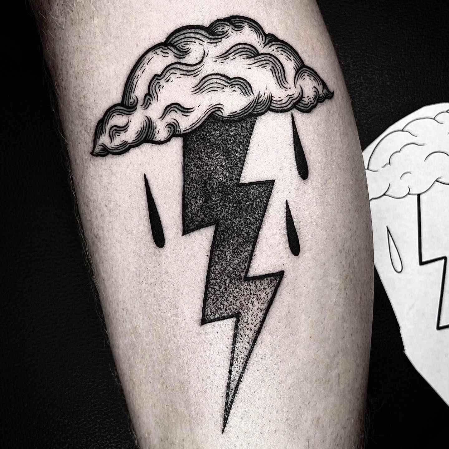 Unique lightning bolt tattoo with cloud design