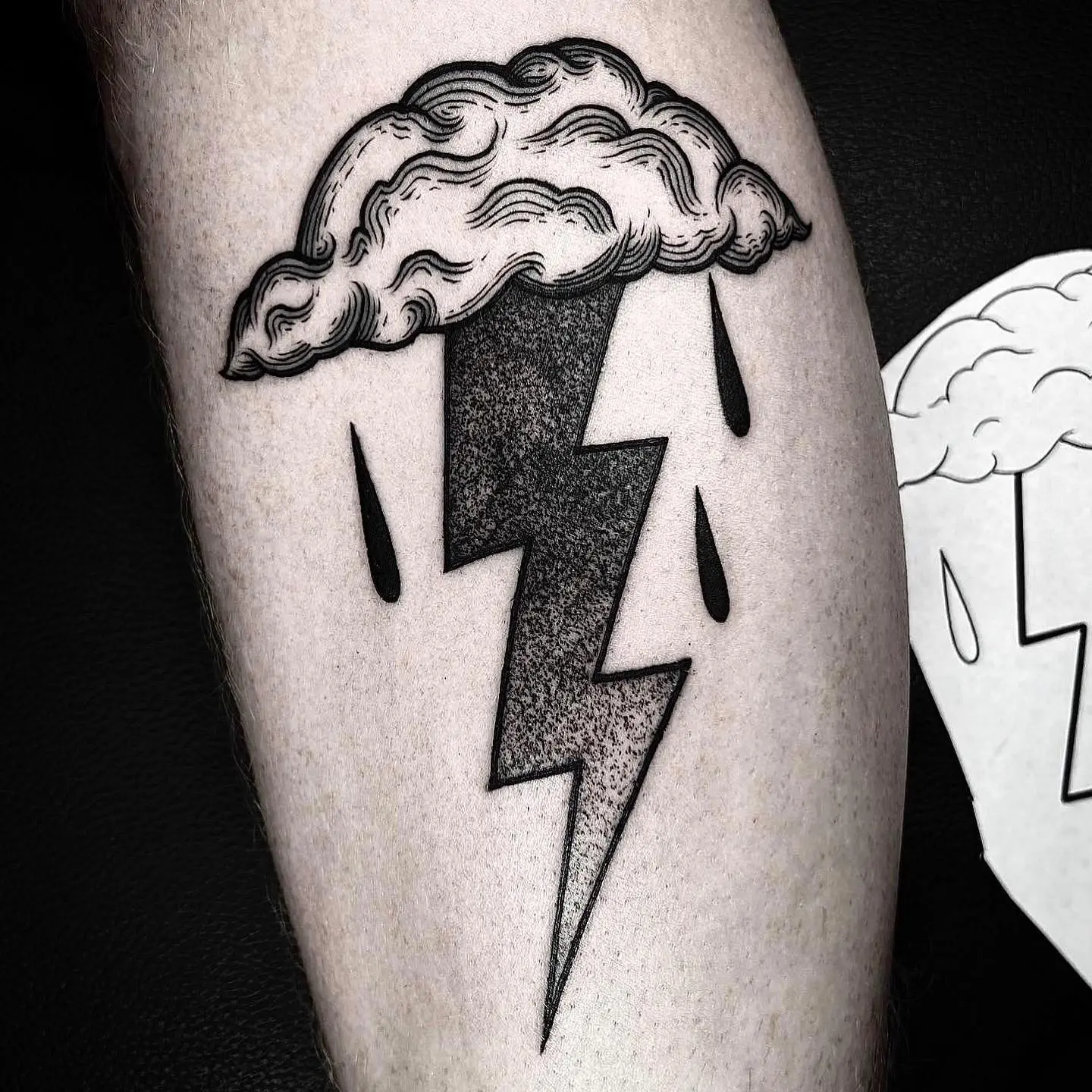 Unique lightning bolt tattoo with cloud design