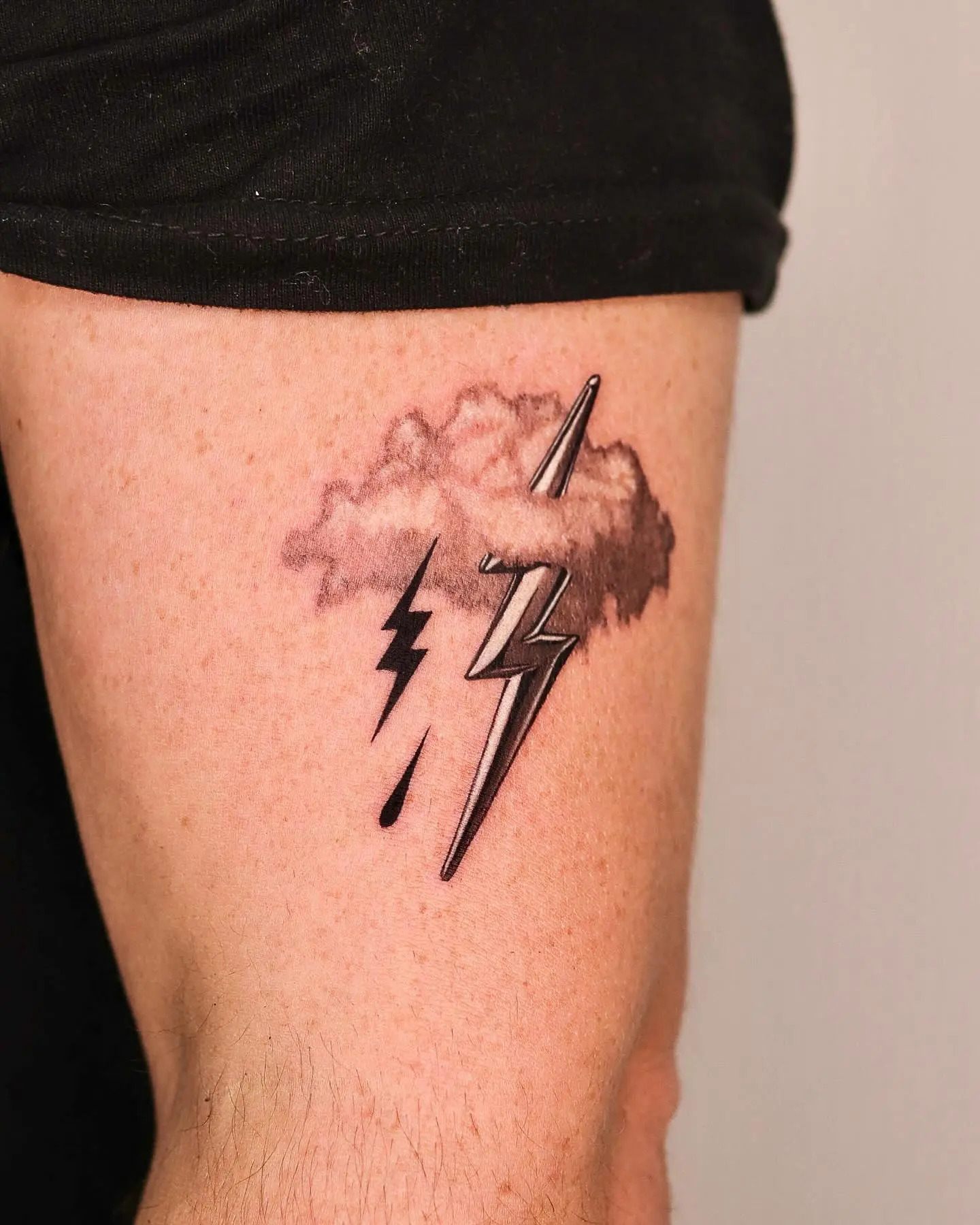 Striking lightning bolt tattoo with cloud design
