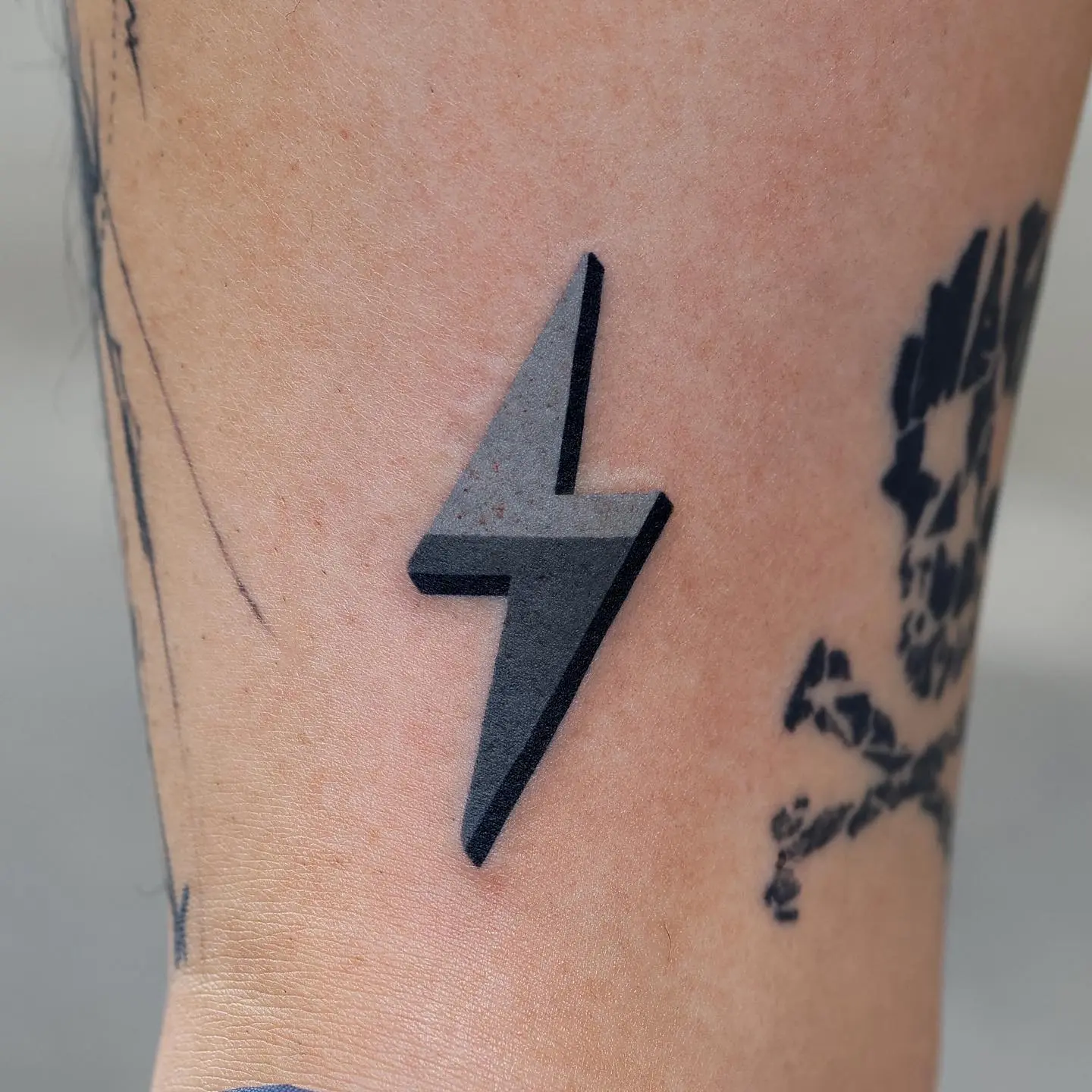 Minimalist lightning bolt tattoo in sleek design