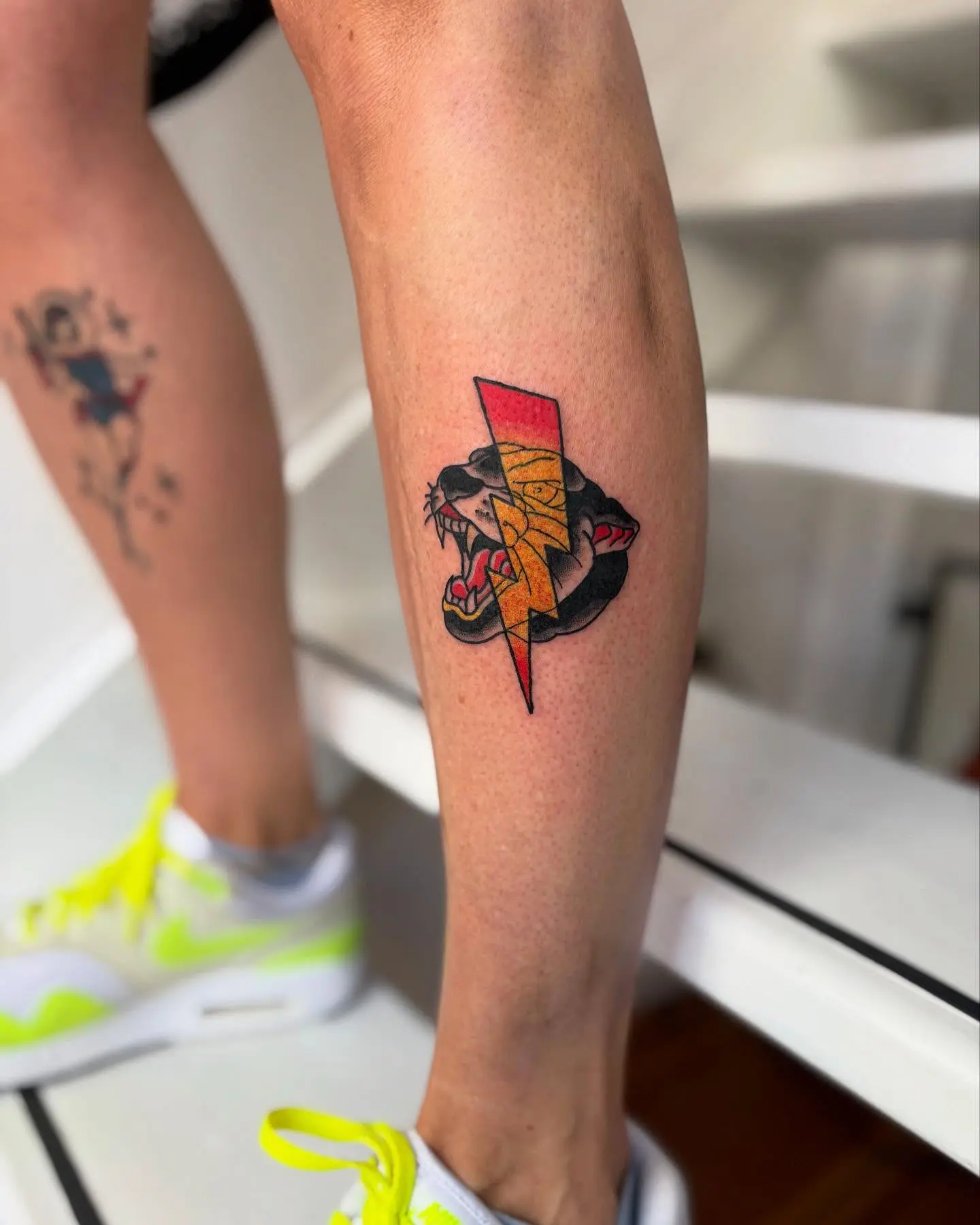 Bold lightning bolt with fierce lion tattoo