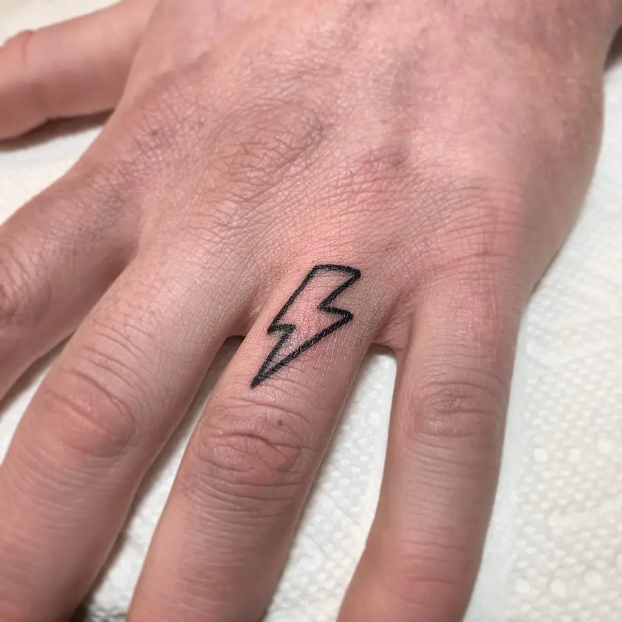 Minimalist lightning bolt tattoo on hand