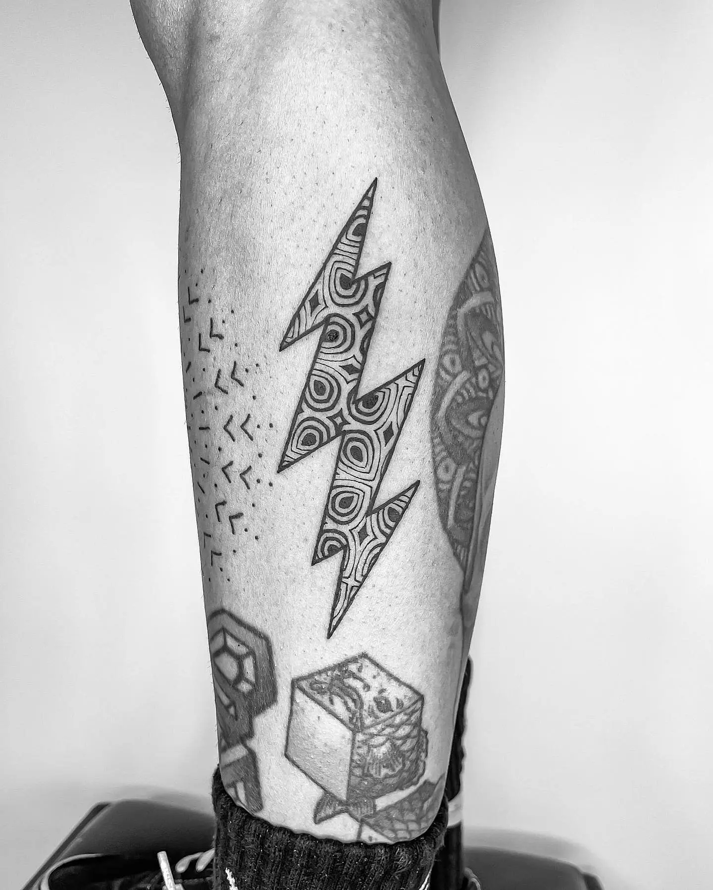 Striking geometric lightning bolt tattoo design