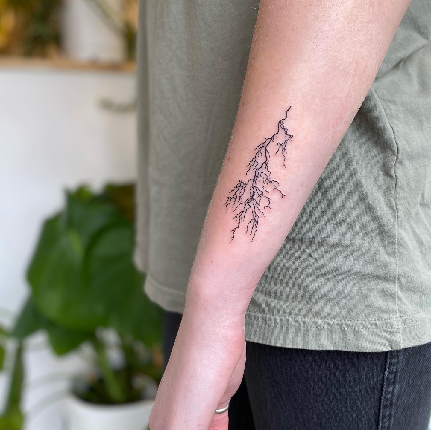 Elegant minimalist lightning bolt tattoo design