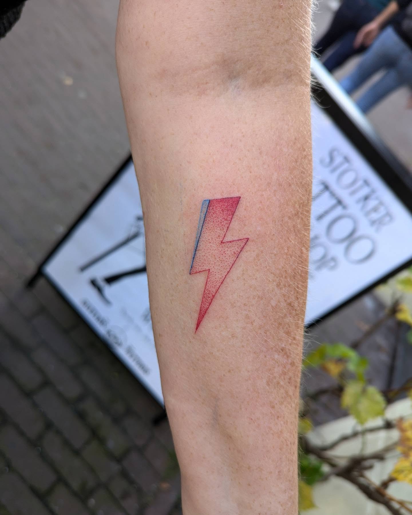 Stunning lightning bolt tattoo in red hues