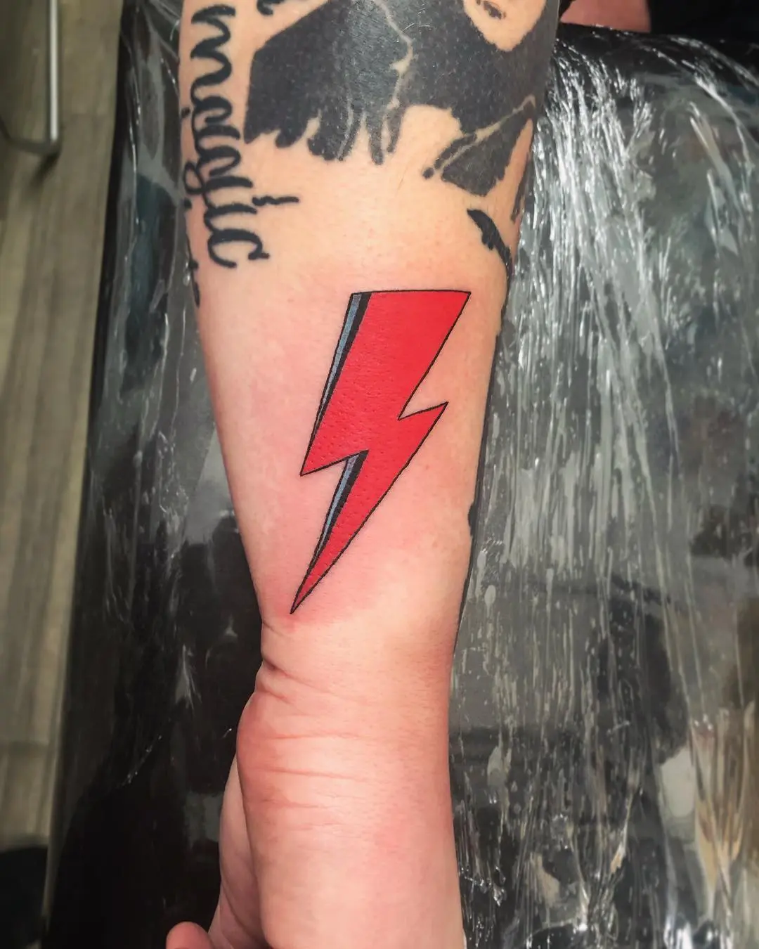 Bold lightning bolt tattoo in striking colors