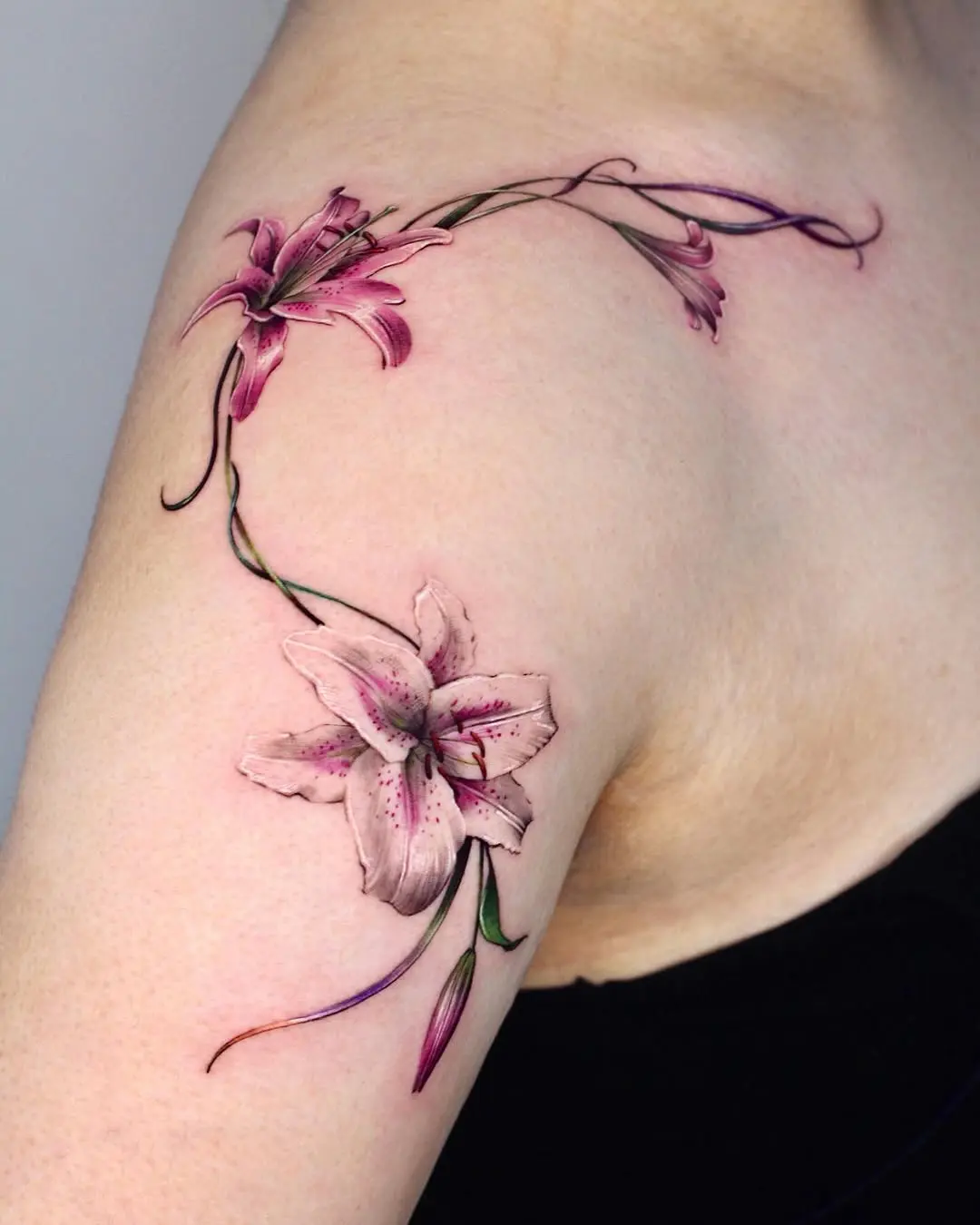Elegant lily tattoo enhancing arm’s beauty