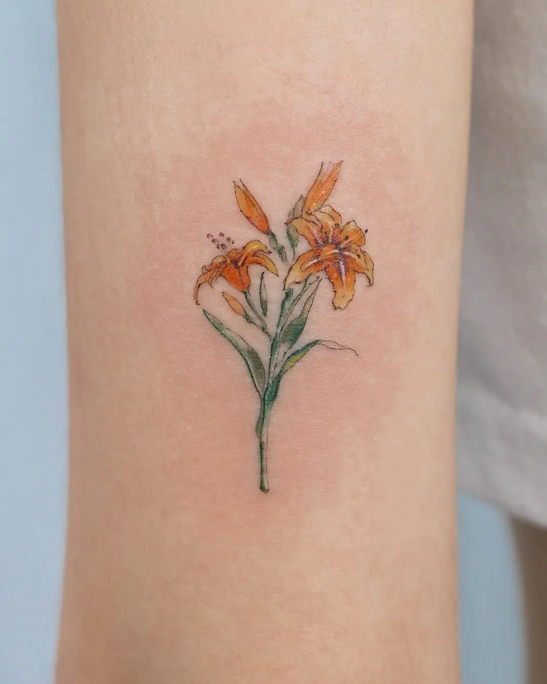 Elegant floral lily tattoo design on skin