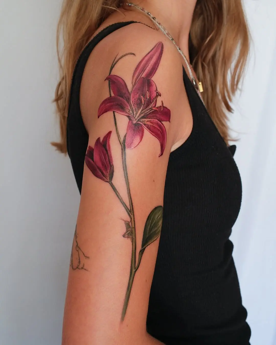 Elegant lilac lily tattoo on the arm