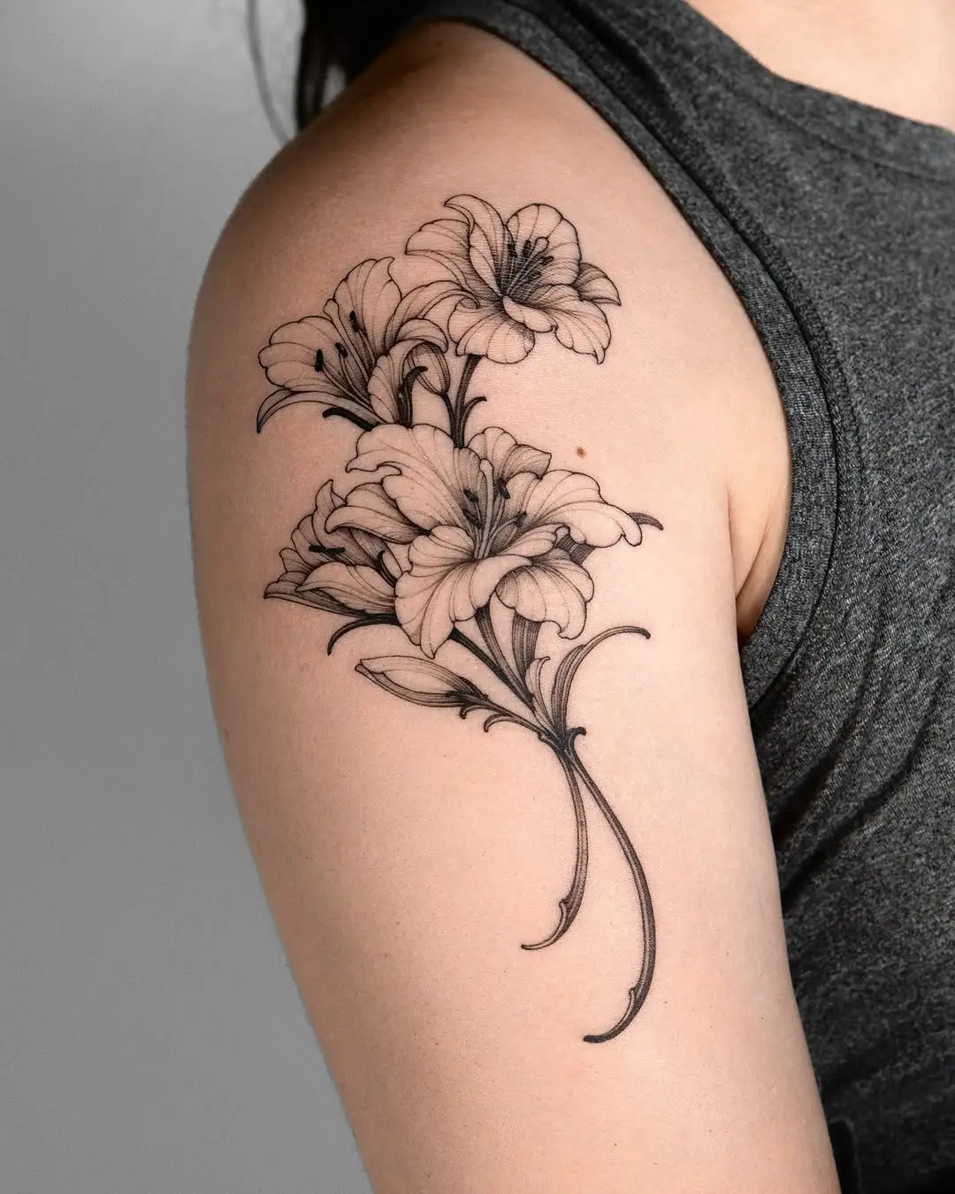 Elegant lily tattoo on the upper arm