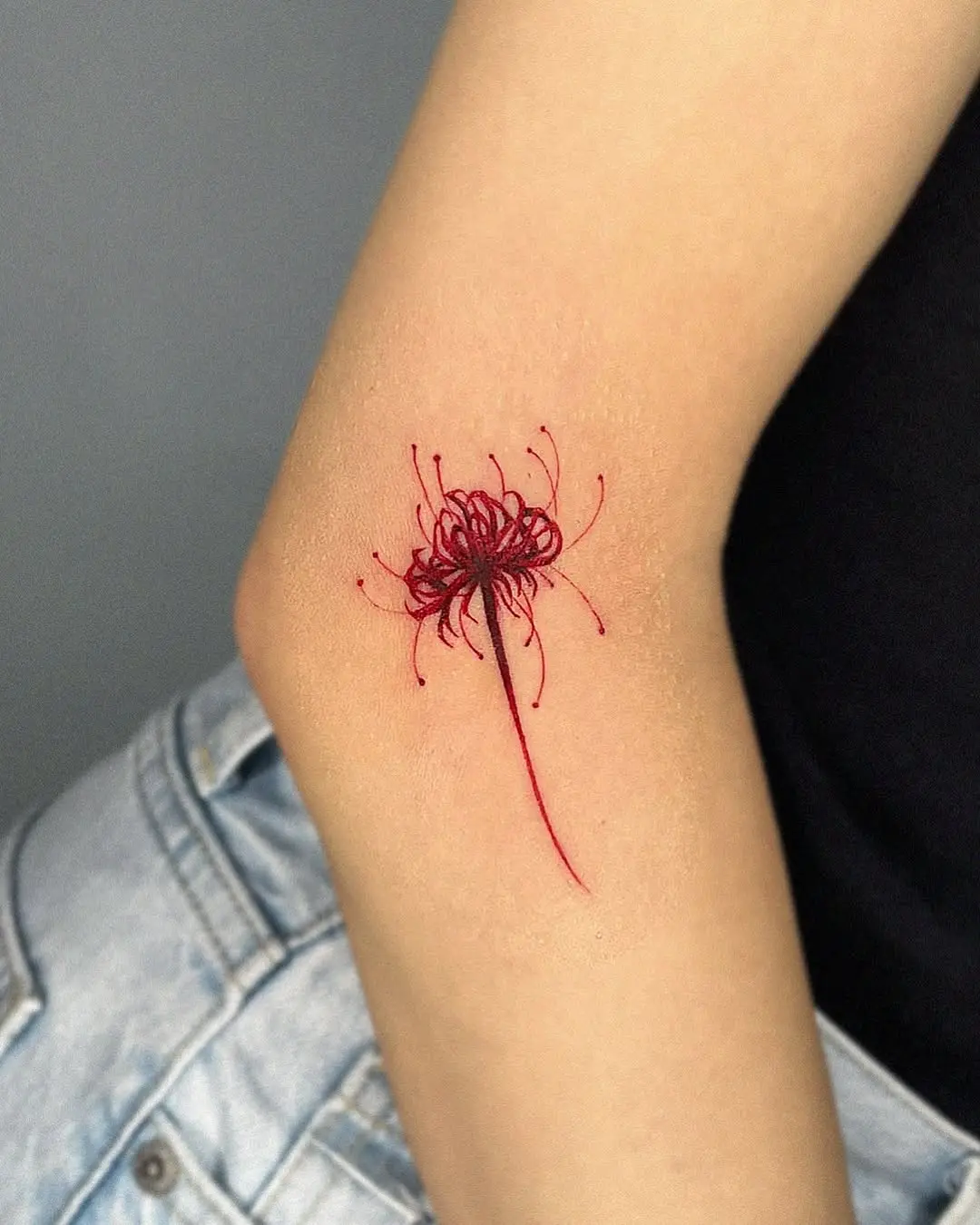 Vibrant Red Lily Tattoo on Arm