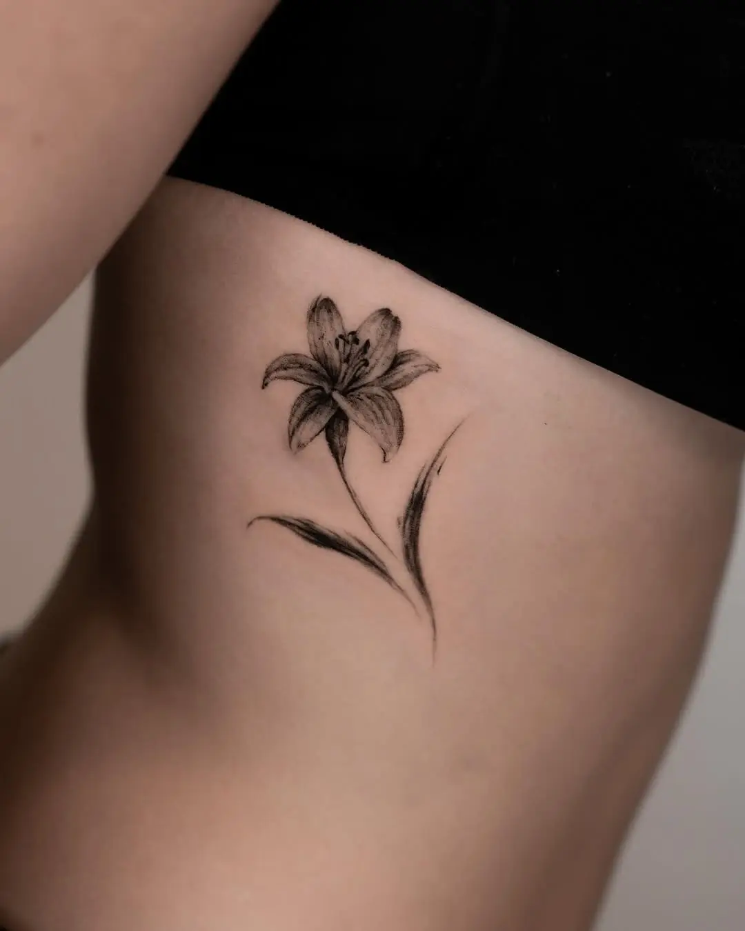 Elegant lily tattoo on the side body