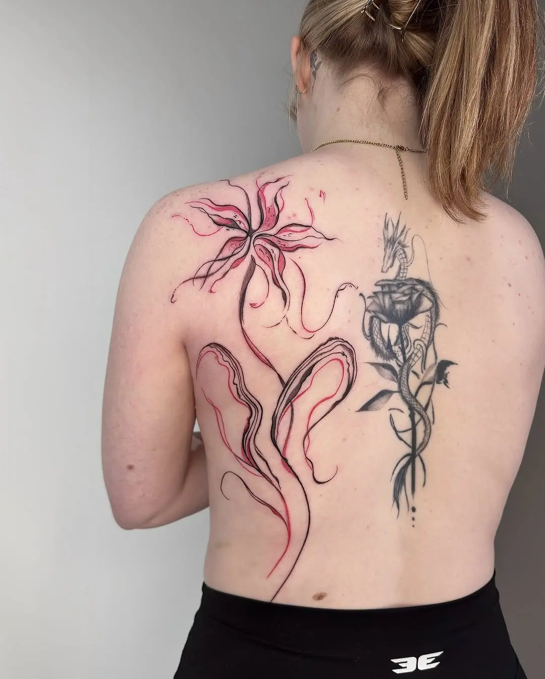 Elegant and vibrant lily tattoo on back
