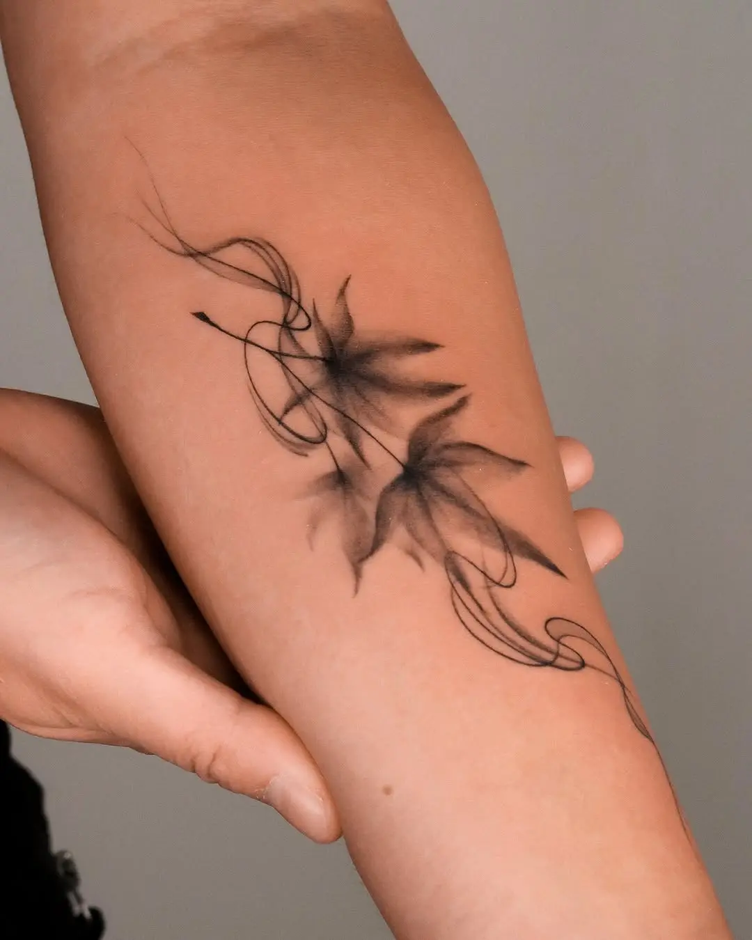 Elegant black and gray maple leaf tattoo